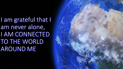 View of the earth from outerspace with the text: I am grateful that I am never alone, I am connected to the world around me.