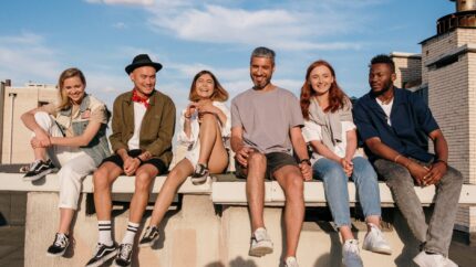 group of people sitting on concrete bench