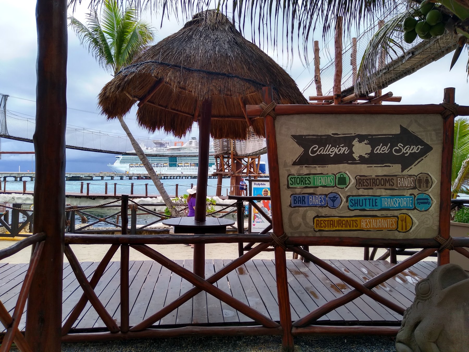 Callejon del Sapo directional sign in the Costa Maya cruise port area with Serenade of the Seas in the background.