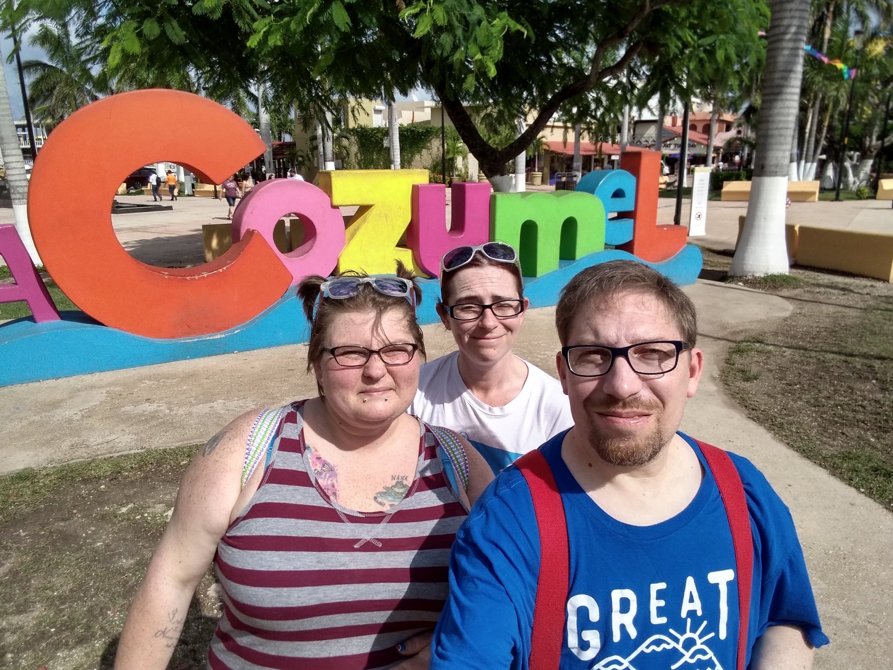 Joe and family at the colorful Cozumel sign.